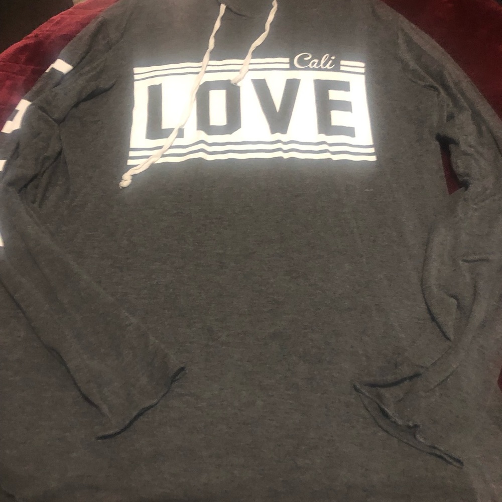 Long sleeve, hoodie. Love printed on the front and down both sleeves.